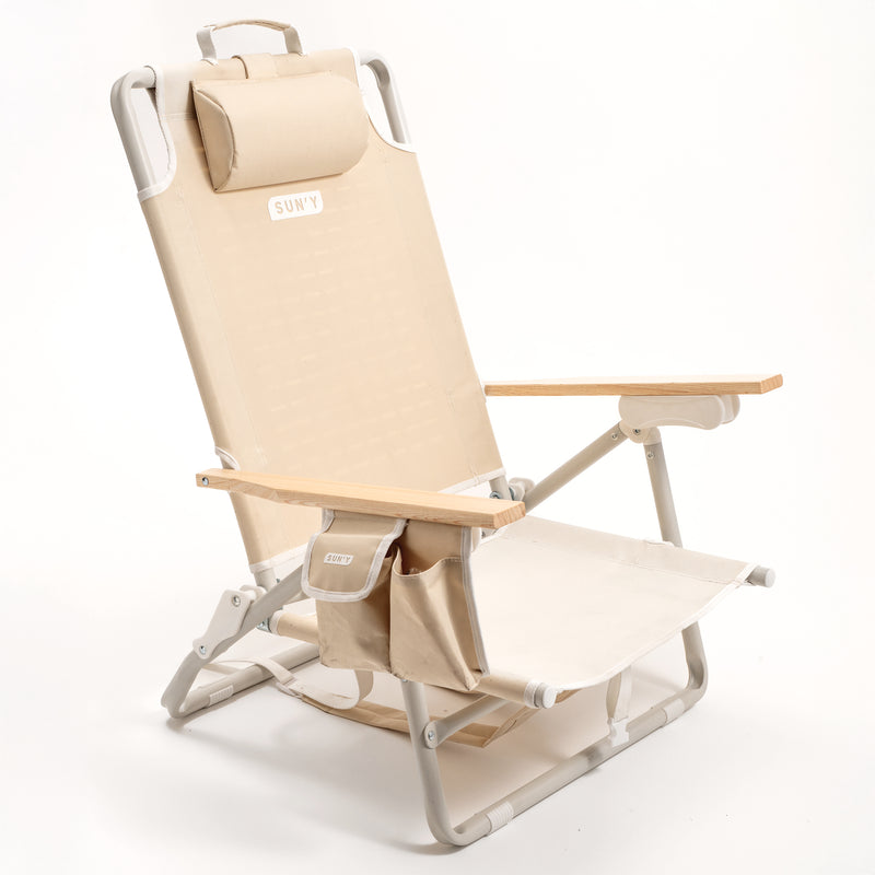 SUN'Y ESCAPES backpack beach chair in Natural Sand color with beachwood armrests and rust-proof aluminum frame